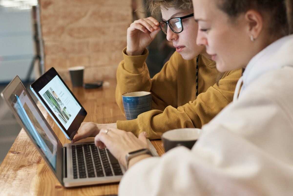 Two people in front of a computer.