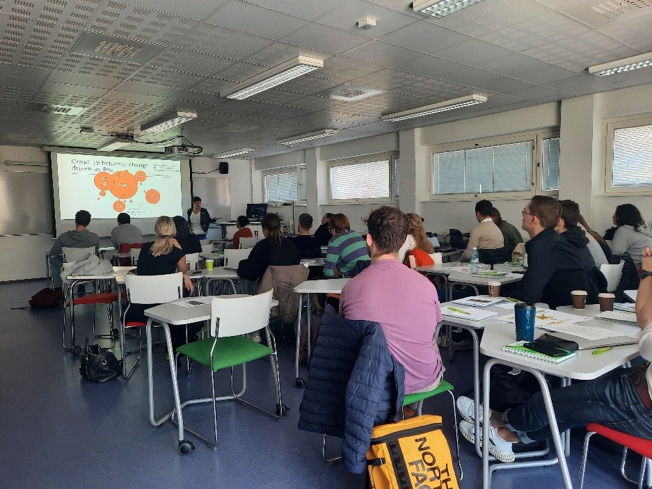 Classroom, students sitting and listening to lecturer at front